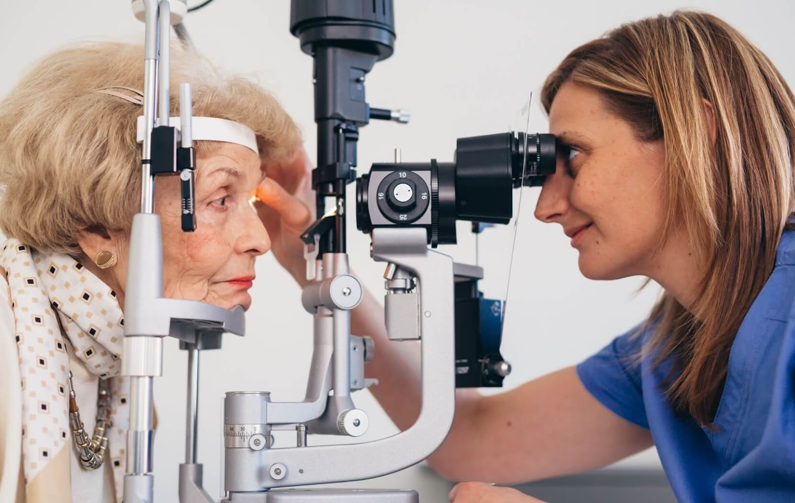 An optometrist uses a slit lamp to thoroughly examine their patient's eyes to check their eyes for any irregularities.